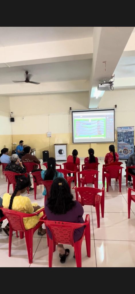 Participants attend the PBMA computer-training session, facing the projected lesson.