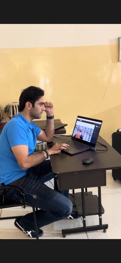 An instructor in a blue shirt demonstrates computer skills at a laptop during the PBMA session.
