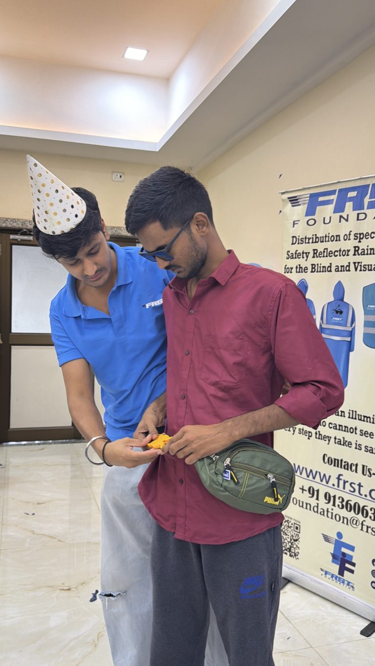 Two people share a moment during a birthday celebration beside an FRST Foundation banner.