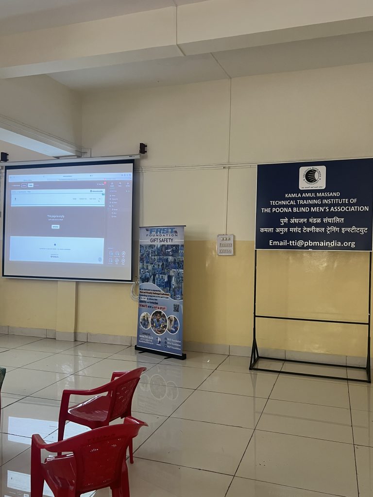A website-design demonstration is projected beside the PBMA technical training institute sign.