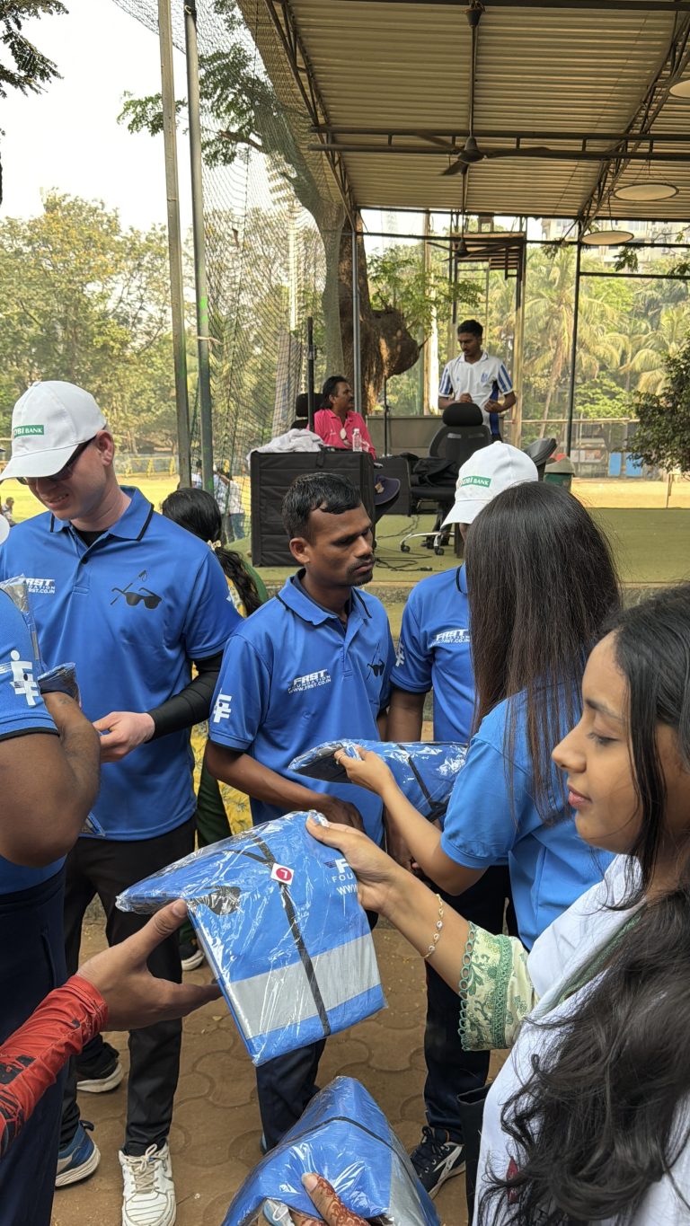 FRST team members present safety gear to blind cricket participants.