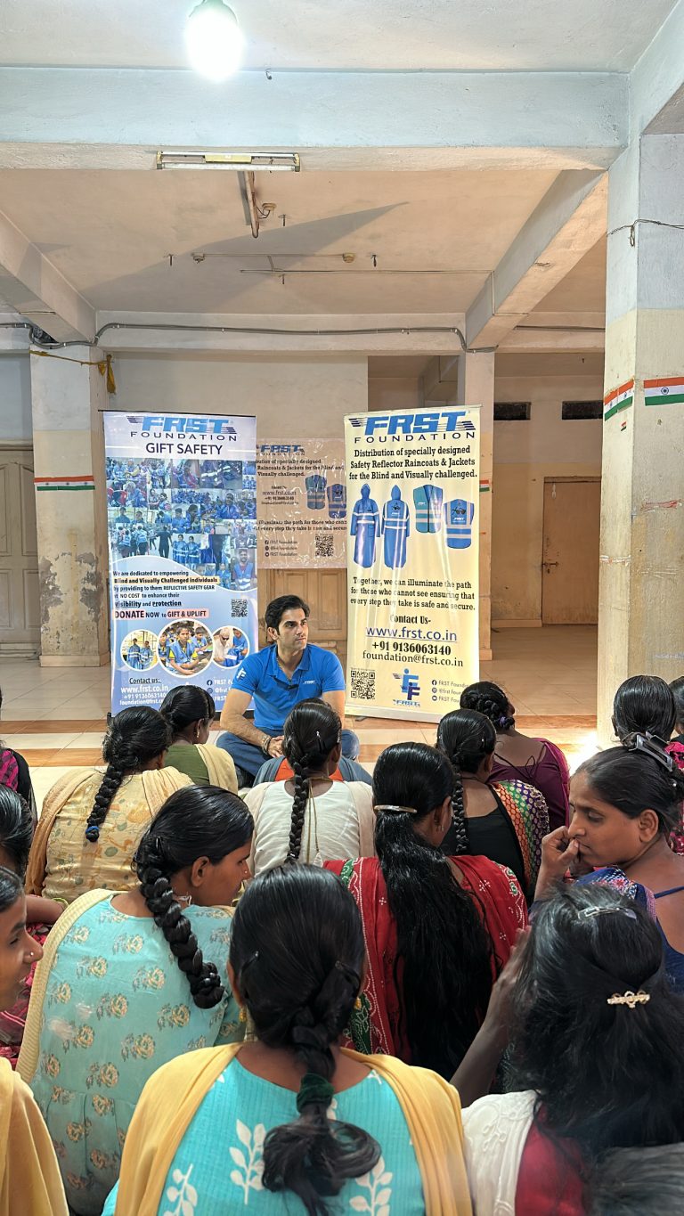 Girls gather around a FRST team member during the community visit in Hyderabad.