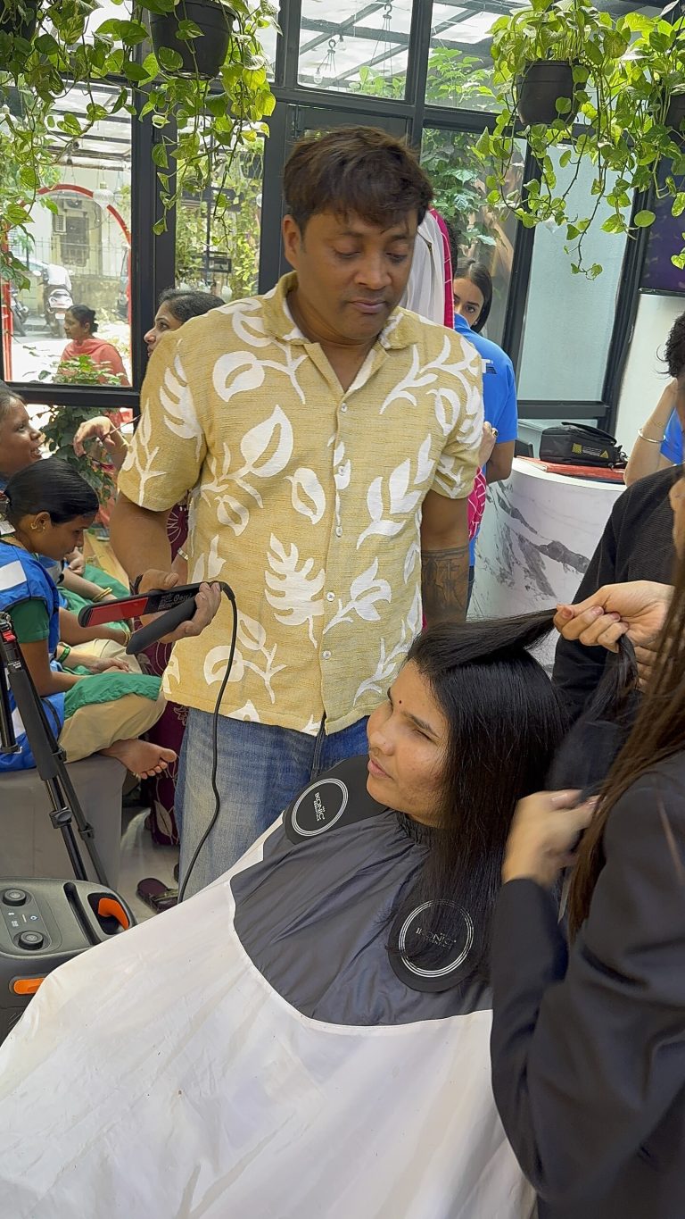 Stylists work on a participant’s hair during the FRST salon outing at THREE by Subby.
