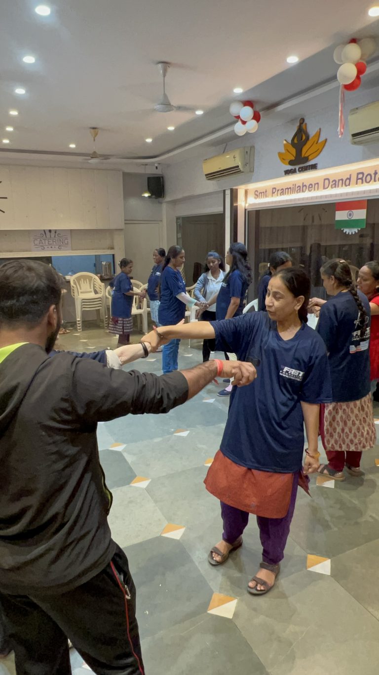 A participant practises a wrist-release movement with guidance during BPA’s self-defence workshop.