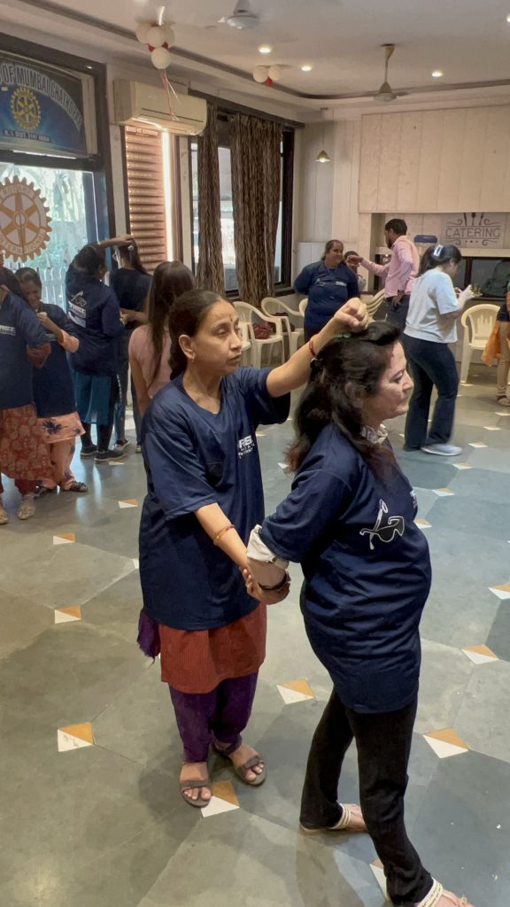 Women practise a self-defence exercise together at a partner workshop.